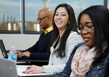 A student smiling toward the camera in class