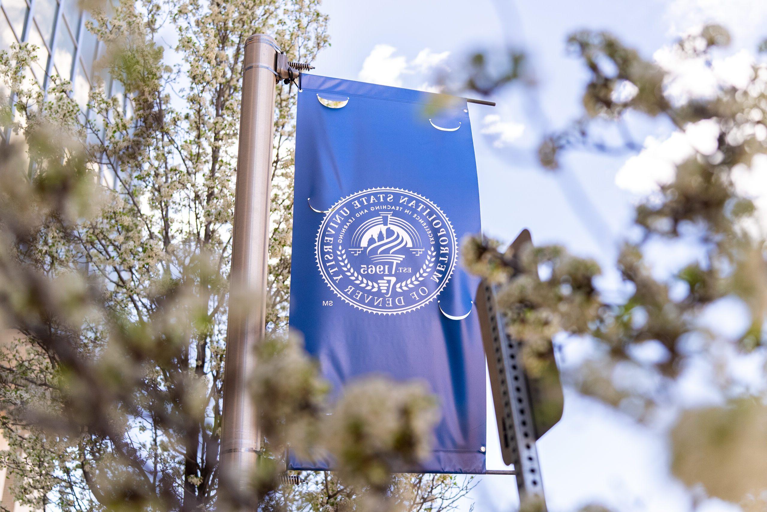 Flowering trees and traveling students on the MSU Denver Campus during spring semester